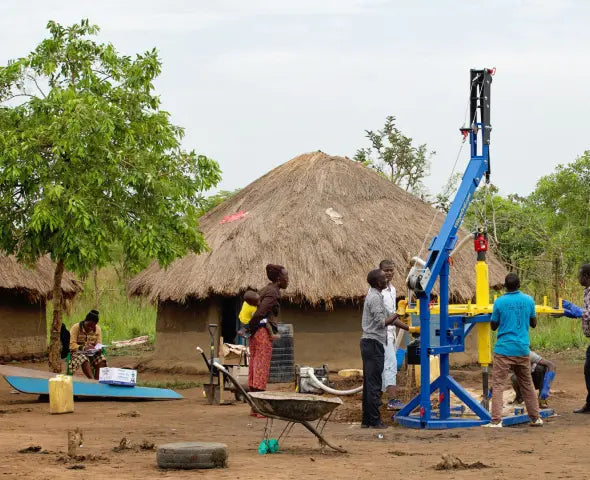 WHOlives drill working in african village to supply water to people in need.